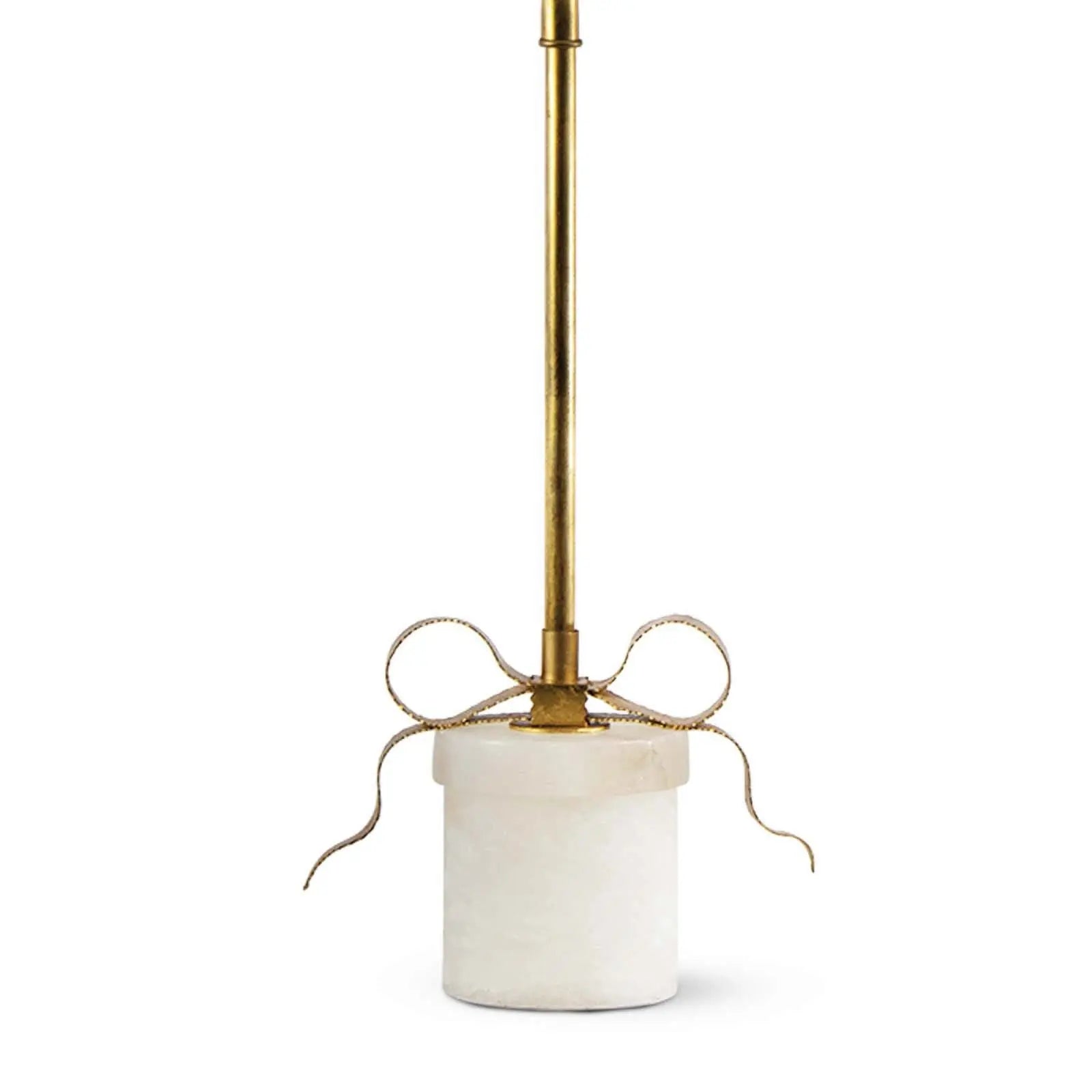 Decorative lamp with brass fixture and white base on a white background