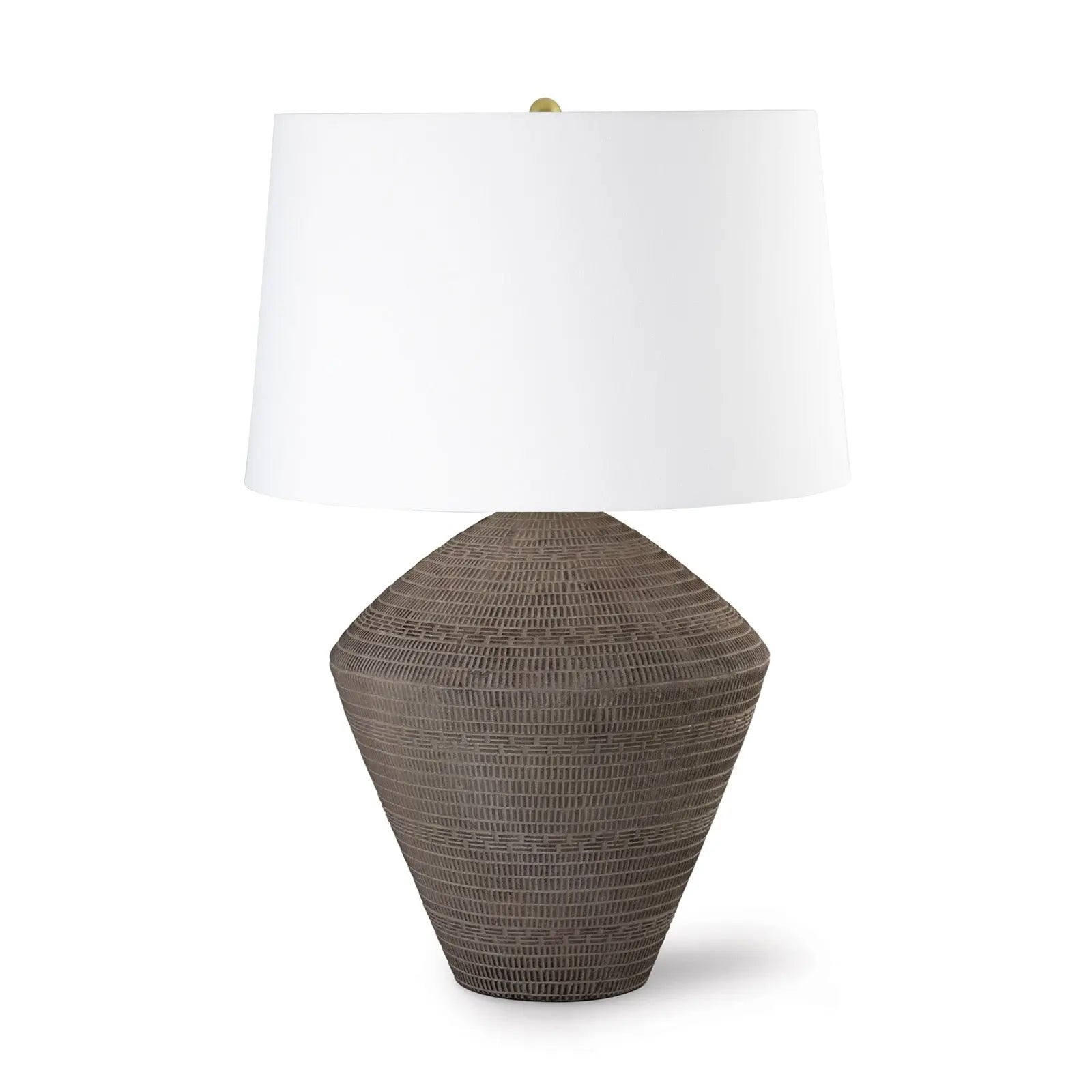 Table lamp with woven brown base and white shade on a white background