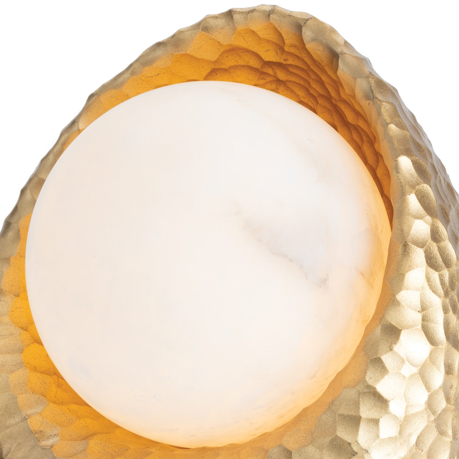 Nest Mini Lamp, a small decorative light fixture with an intricate gold resin hammered base and a round, soft glowing alabaster sphere.
