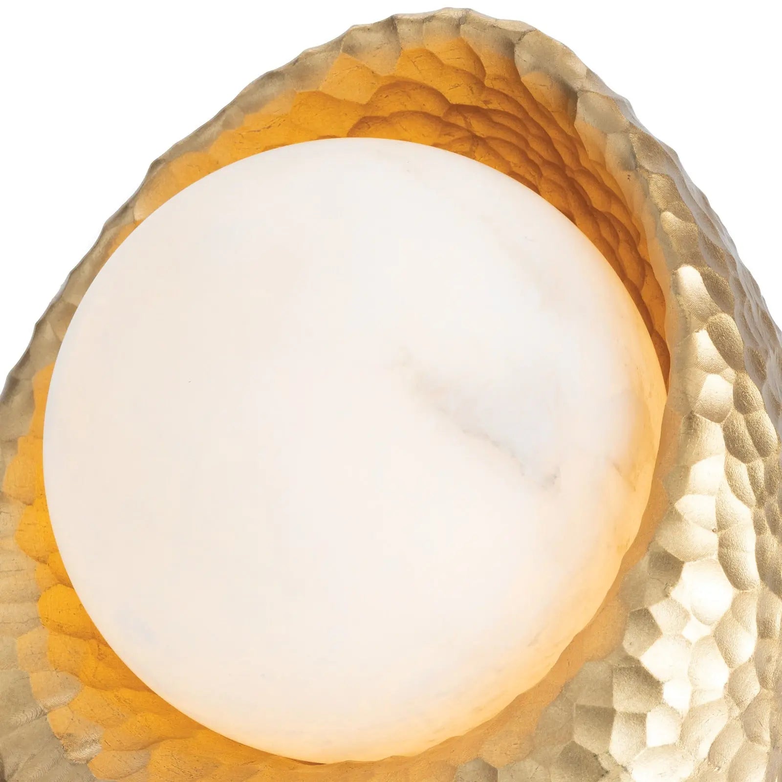 Nest Mini Lamp, a small decorative light fixture with an intricate gold resin hammered base and a round, soft glowing alabaster sphere.