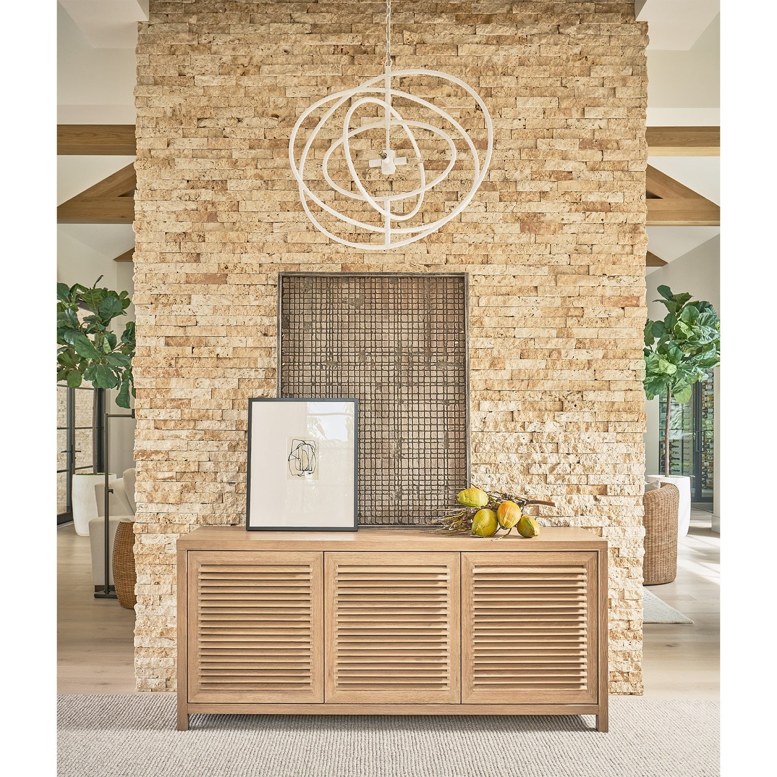 Wooden console table against a stone wall with decorative elements