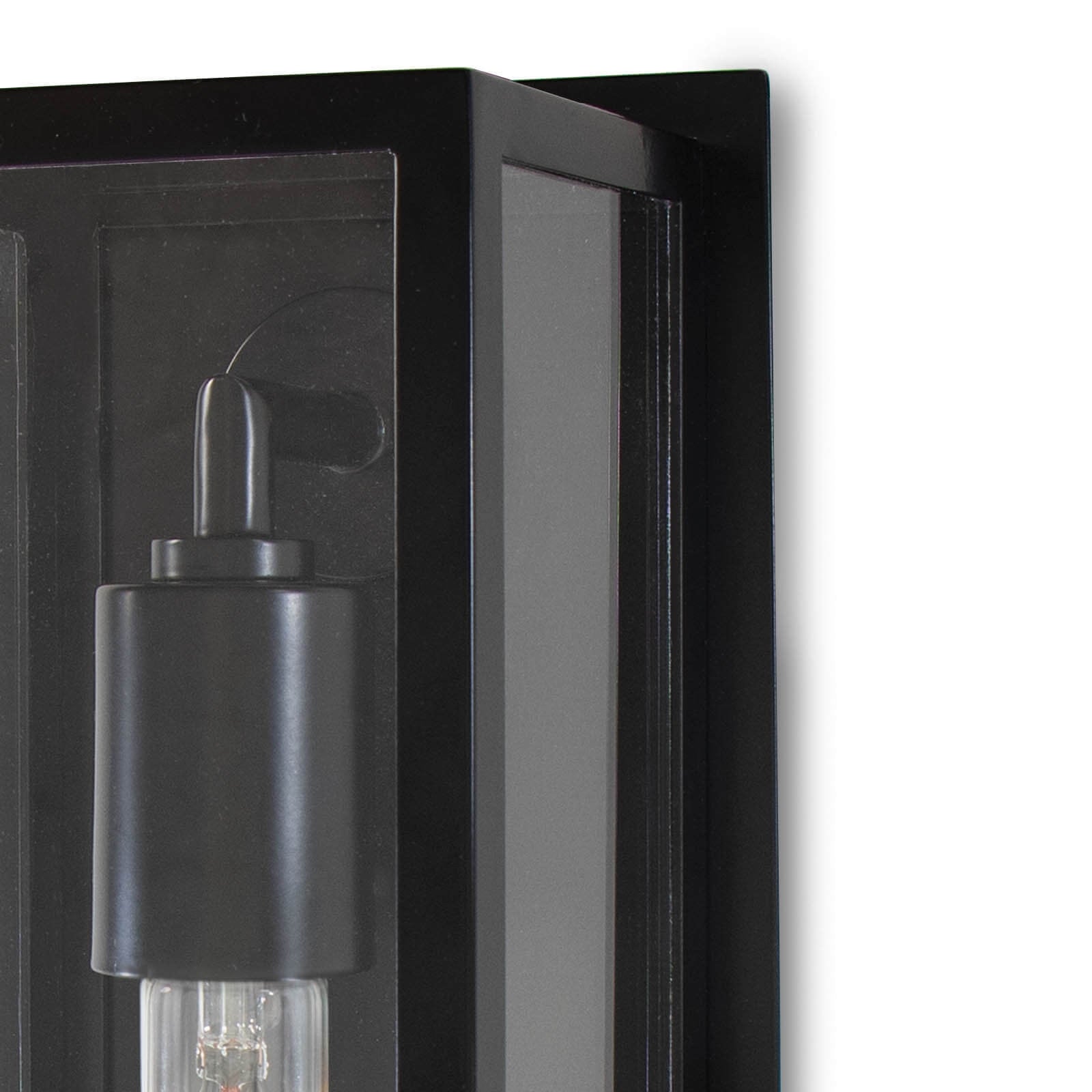 Black outdoor wall light fixture on a white background