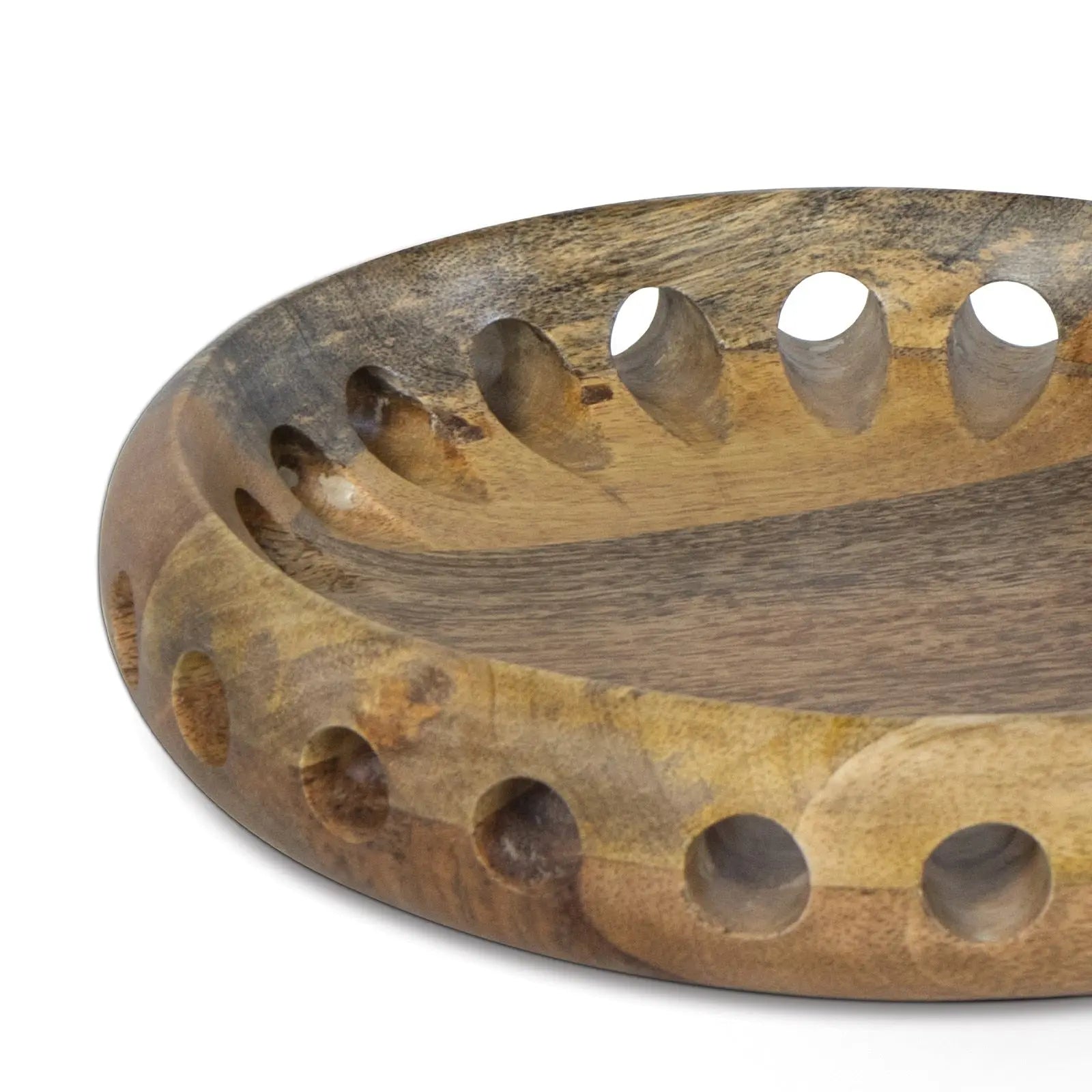 Wooden bowl with circular holes on a white background