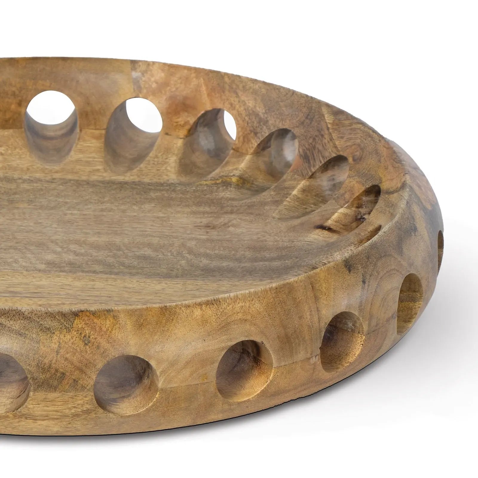 Wooden bowl with circular holes on a white background
