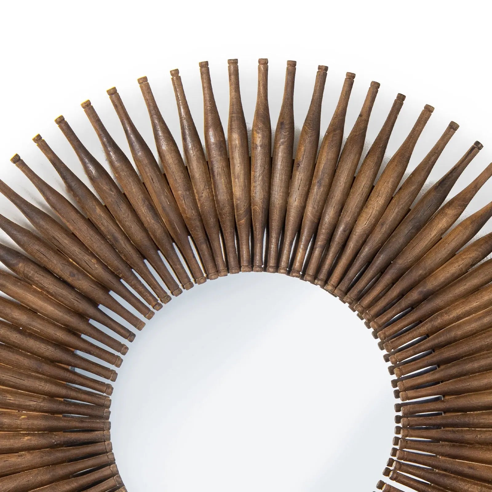 Wooden circular mirror with sunburst design on a white background