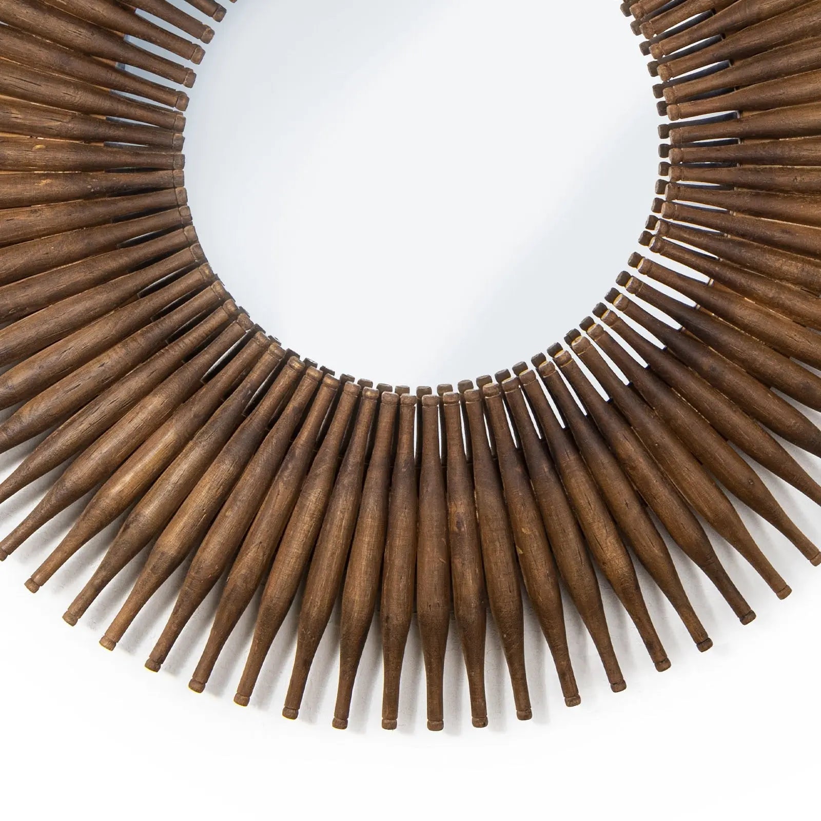 Wooden circular wall art with pointed ends on a white background