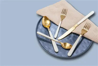 5pc Gold Flatware Place Setting with sleek White Resin Handles. Includes 5 pieces in a gift box. Luxurious, modern, and perfect for elegant dining. Hand wash only.