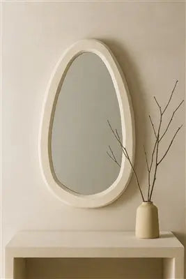 A large round wall mirror featuring a thick, textured off-white frame made from sustainable paper mache with a smooth, artisanal finish.