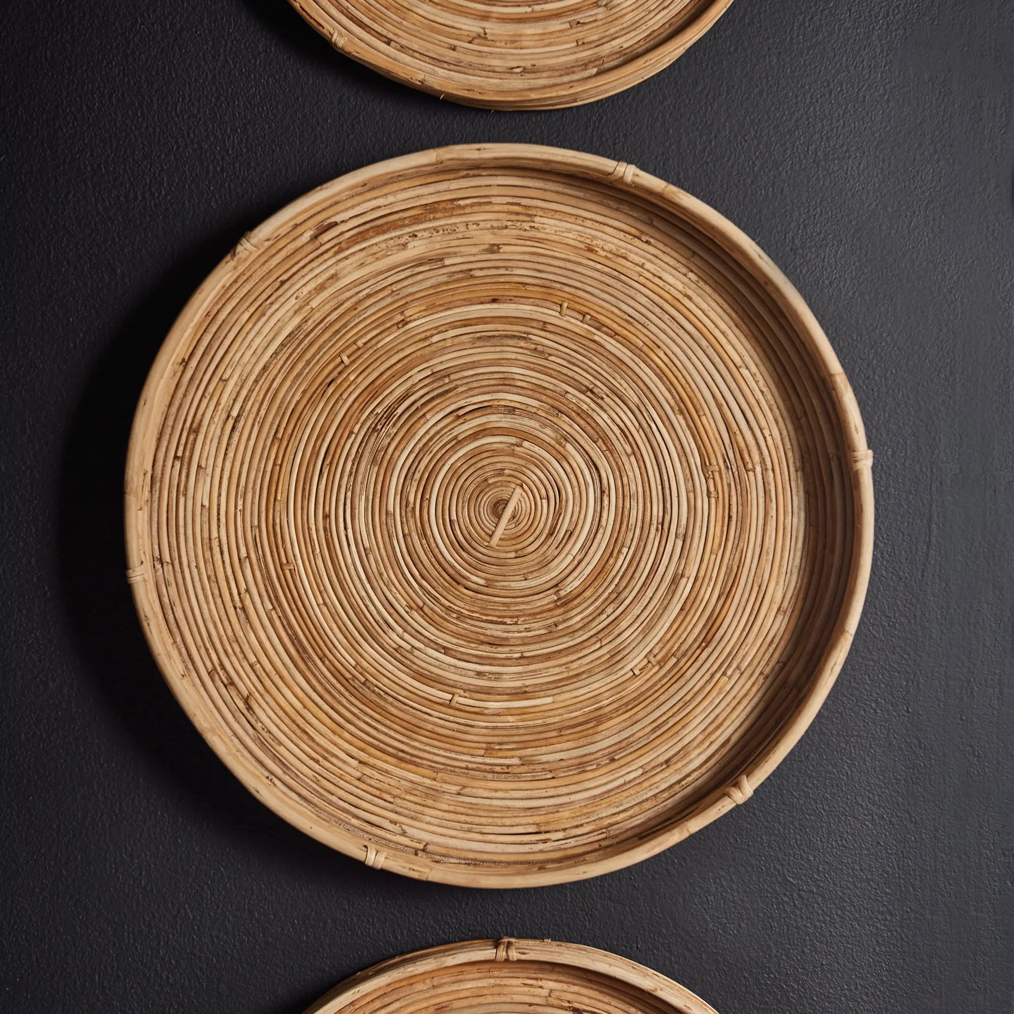 Woven rattan plates on a dark background