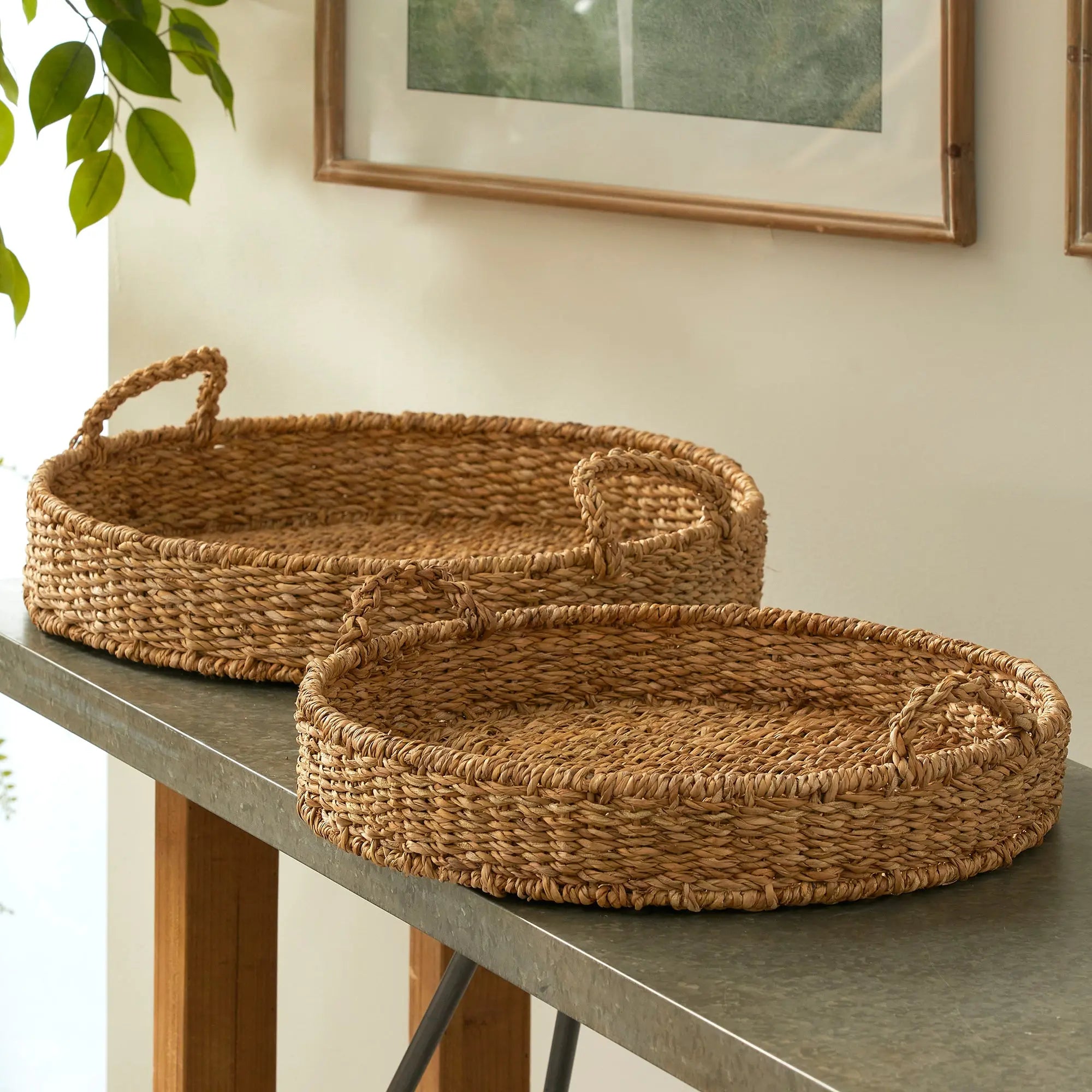 Two woven baskets on a table with a neutral background
