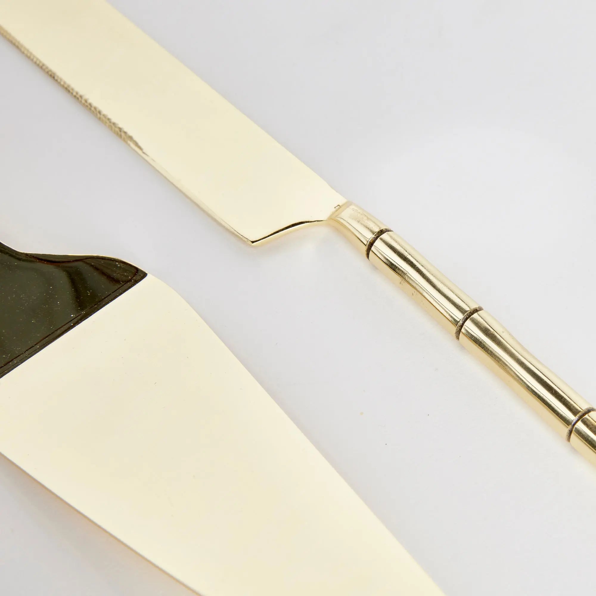 Stainless steel Grove dessert servers inside open retail gift box