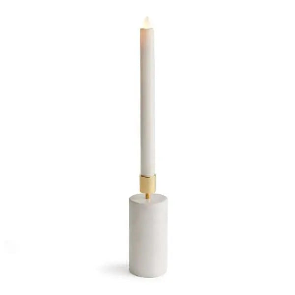 Avalyn Taper Holder, showing a modern taper candle holder with a square white marble base and a cylindrical brushed brass top. The holder is empty and is shown from a slight angle against a neutral background.