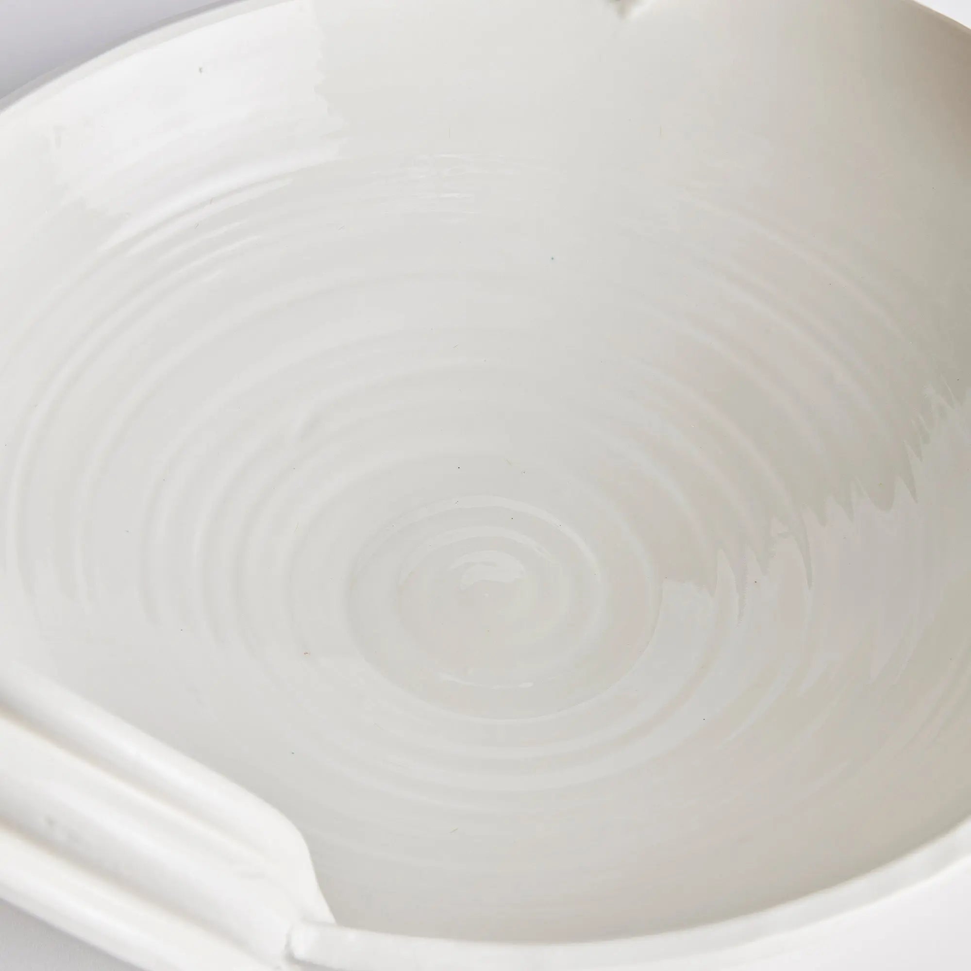 Close-up of a white ceramic bowl with subtle patterns