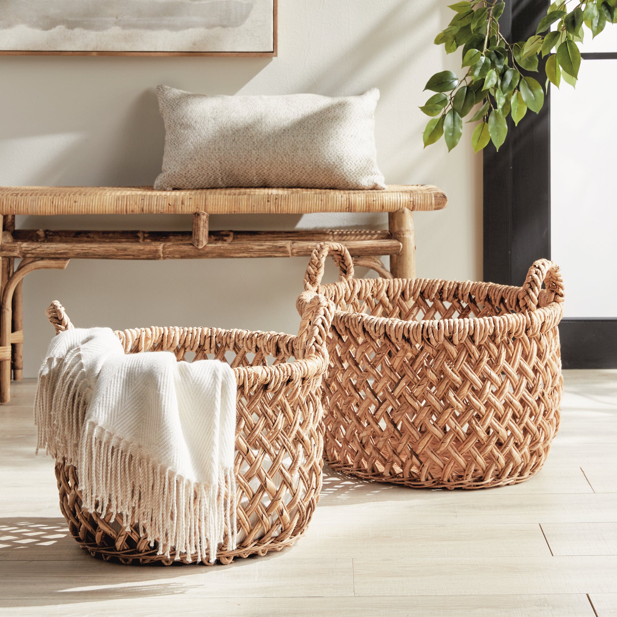 Emlyn Woven Storage Baskets with Handles – Set of 2 (Banana Leaf) - Woven baskets with a blanket on a wooden floor in a home setting