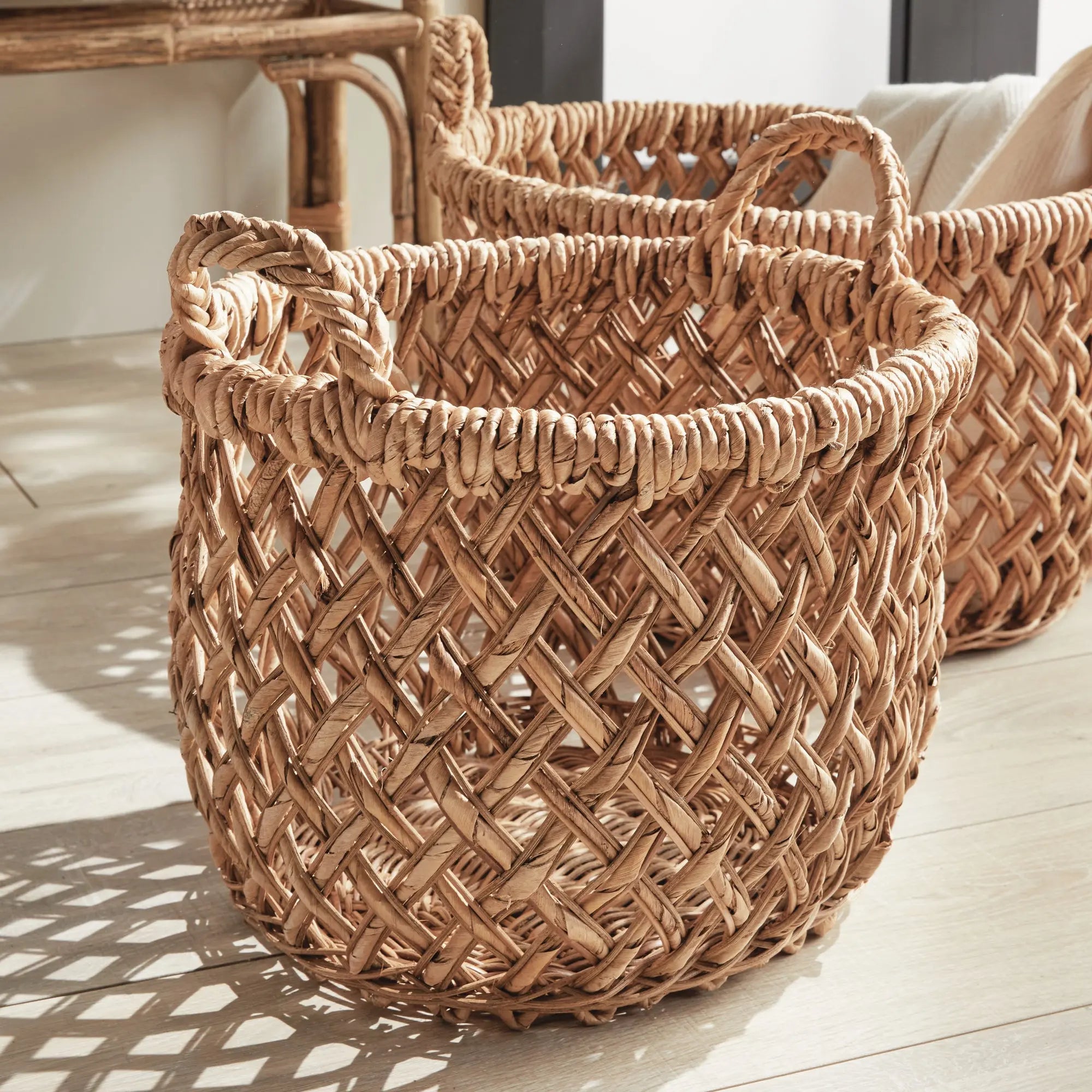 Emlyn Woven Storage Baskets with Handles – Set of 2 (Banana Leaf) - Woven baskets on a wooden floor