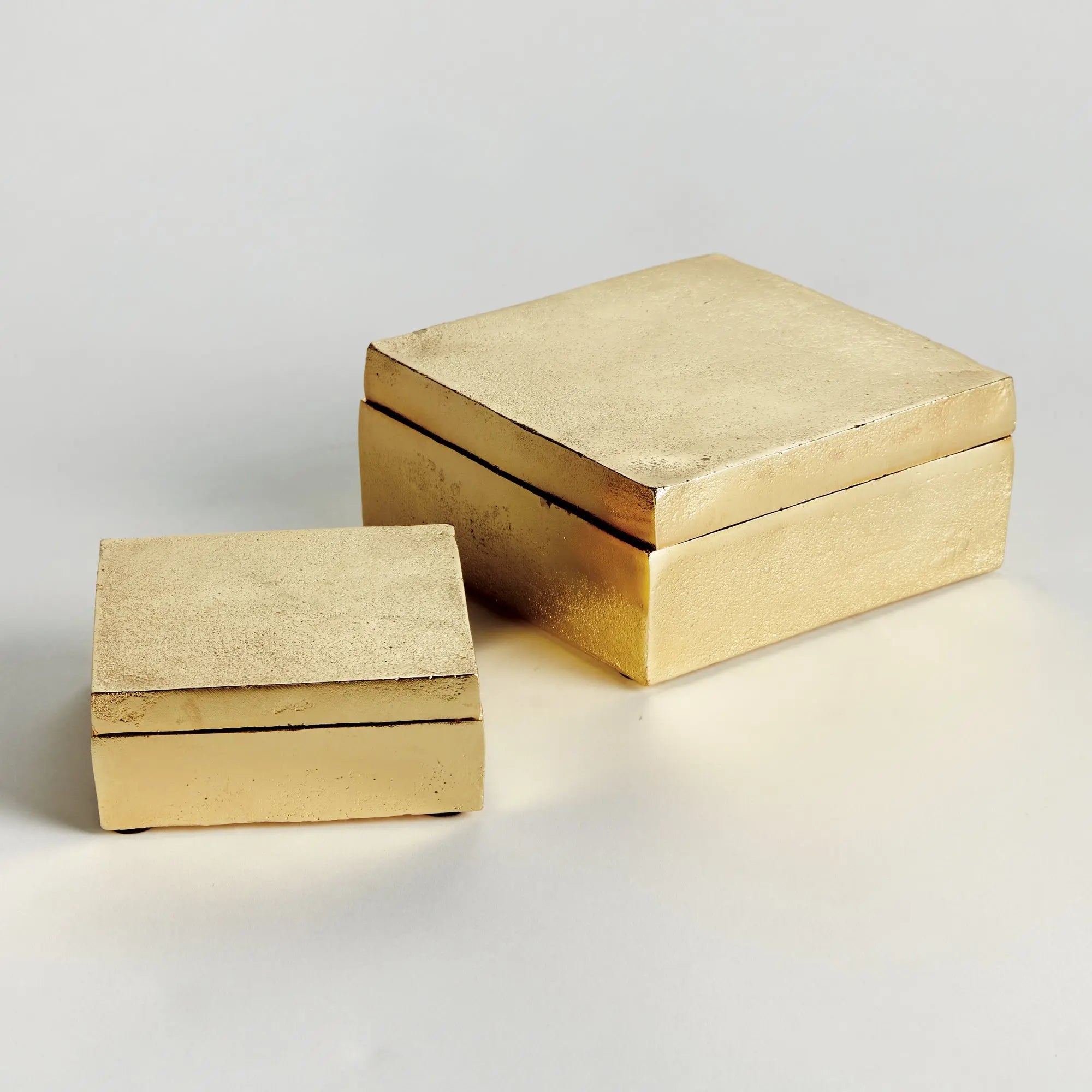 Set of 2 gold Cressida lidded boxes handcrafted from sand-cast aluminum