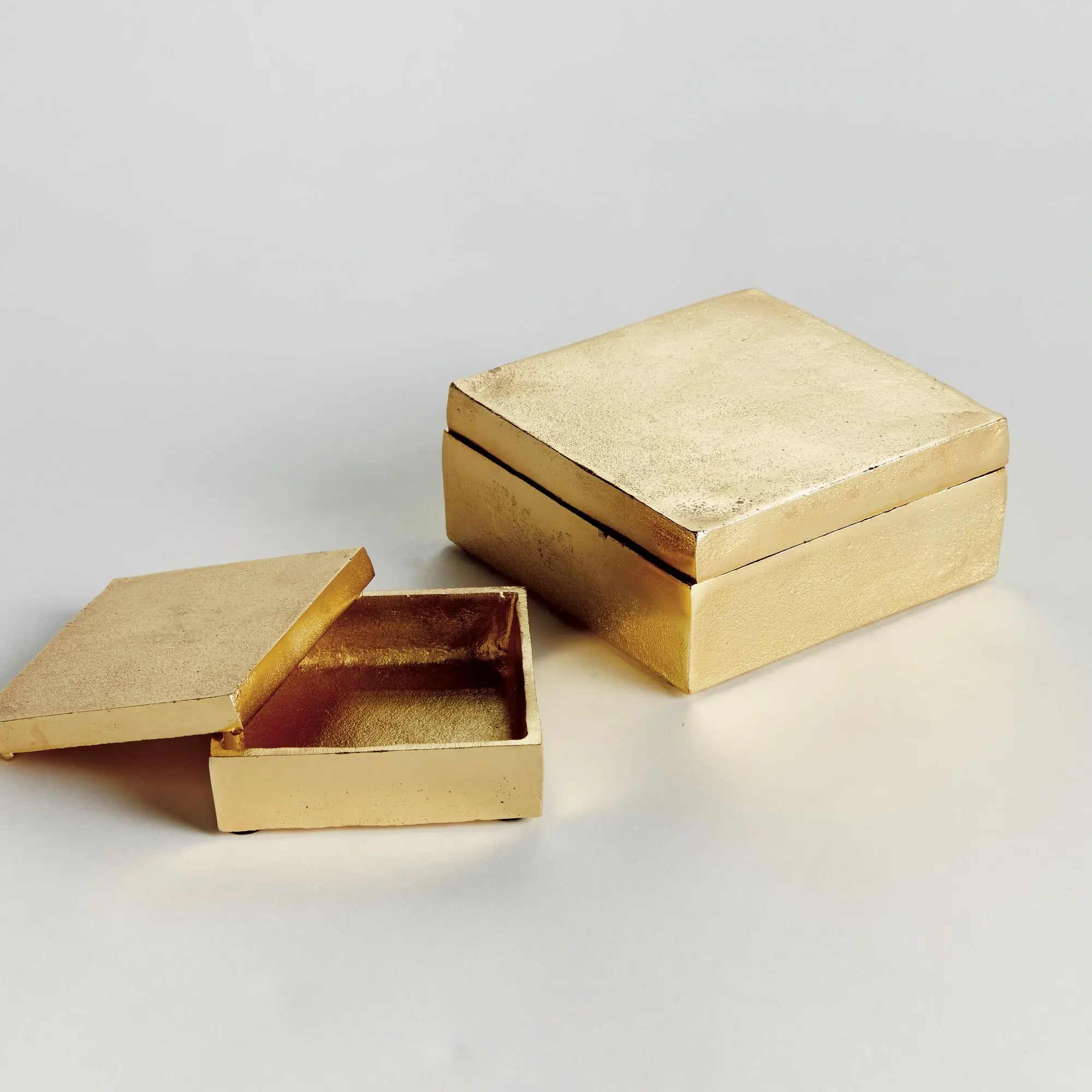 Set of 2 gold Cressida lidded boxes handcrafted from sand-cast aluminum