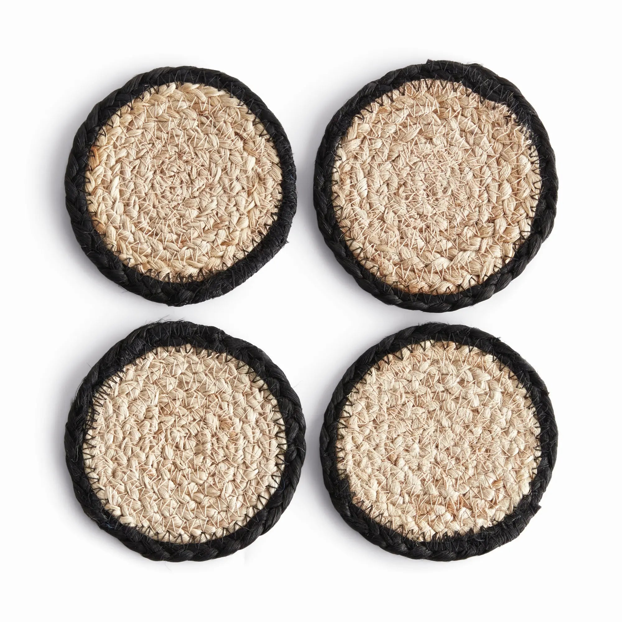 Four round woven coasters with black rims on a white background