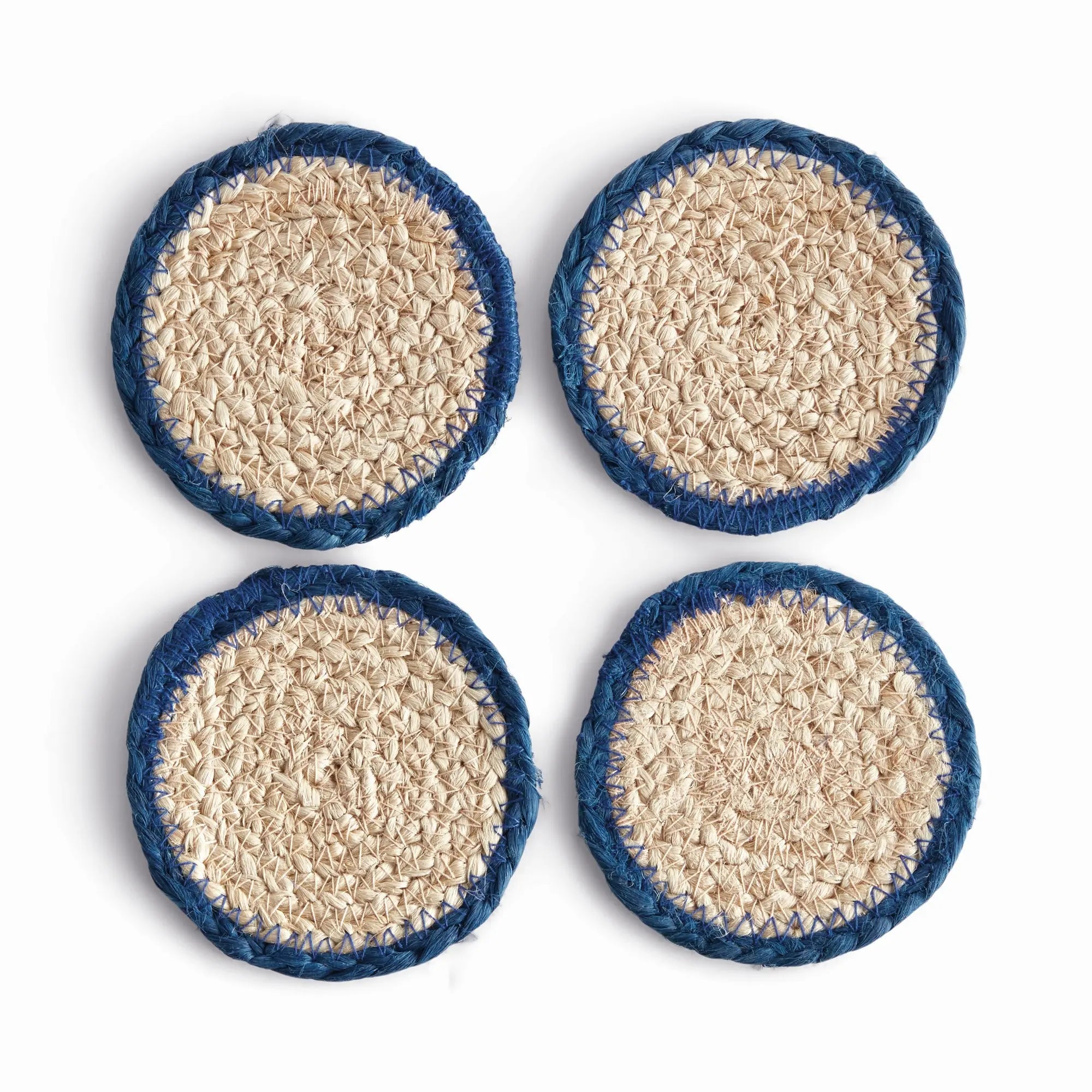 Four round coasters with blue rims and textured beige centers on a white background