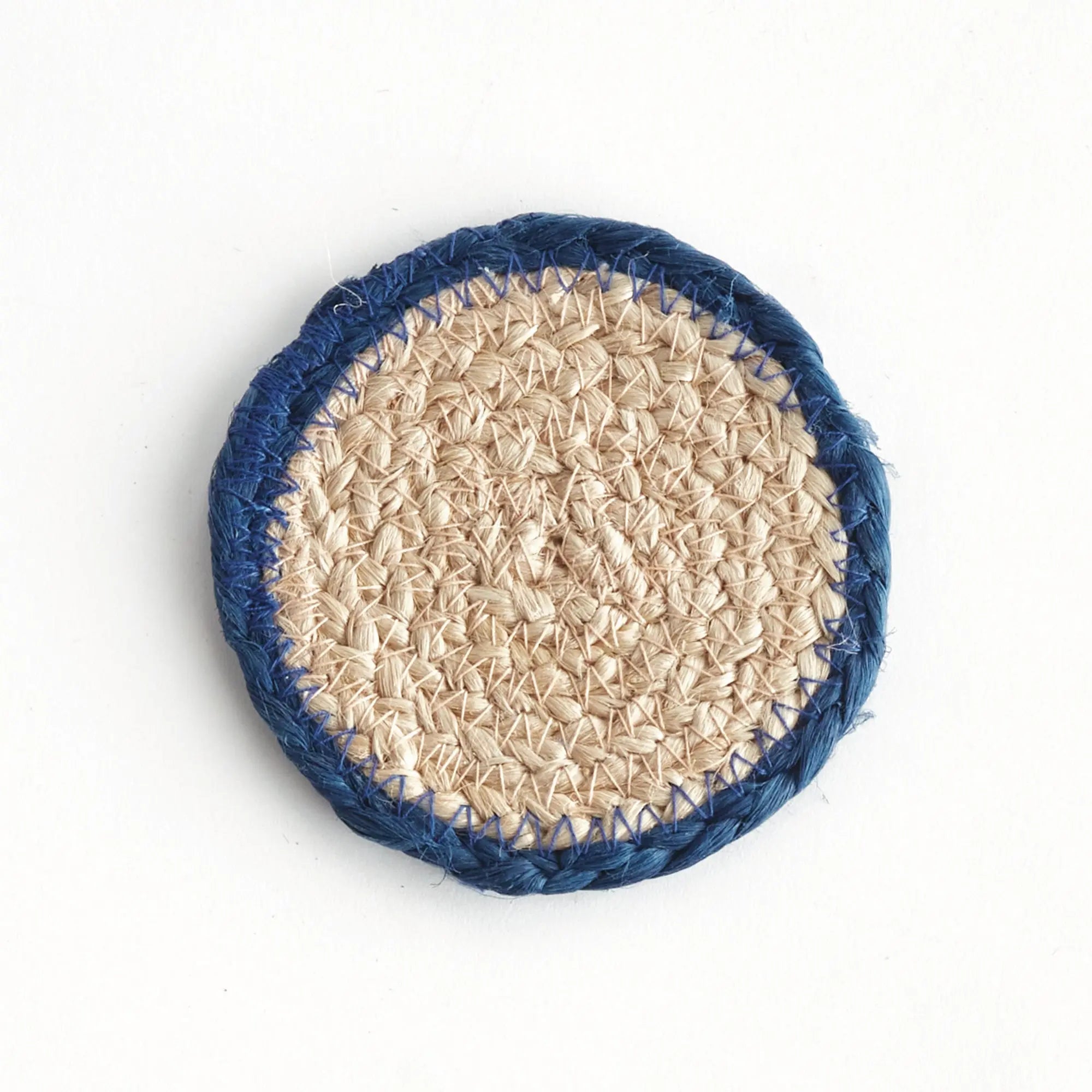 Round woven coaster with blue rim on a white background
