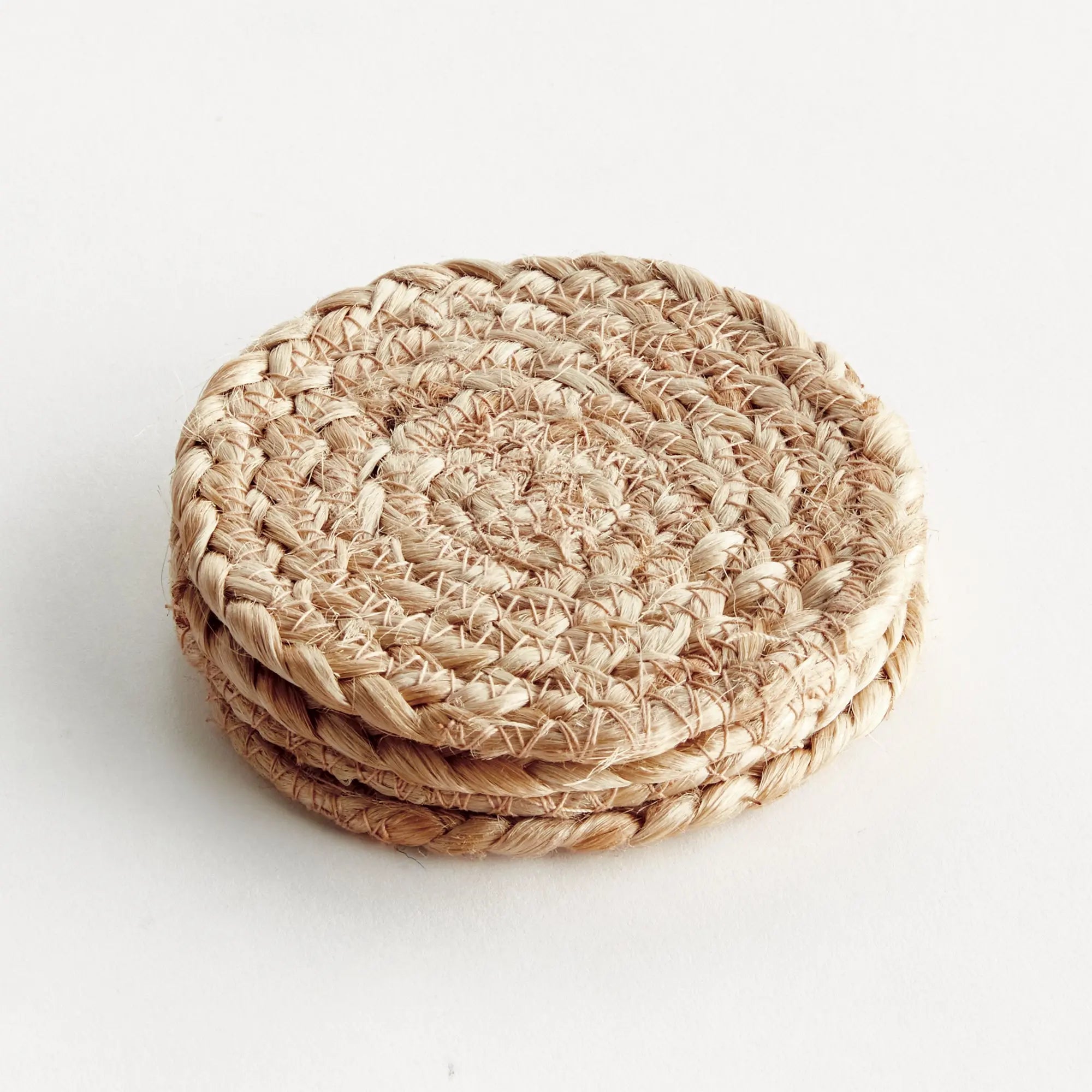 Stack of woven coasters on a white background
