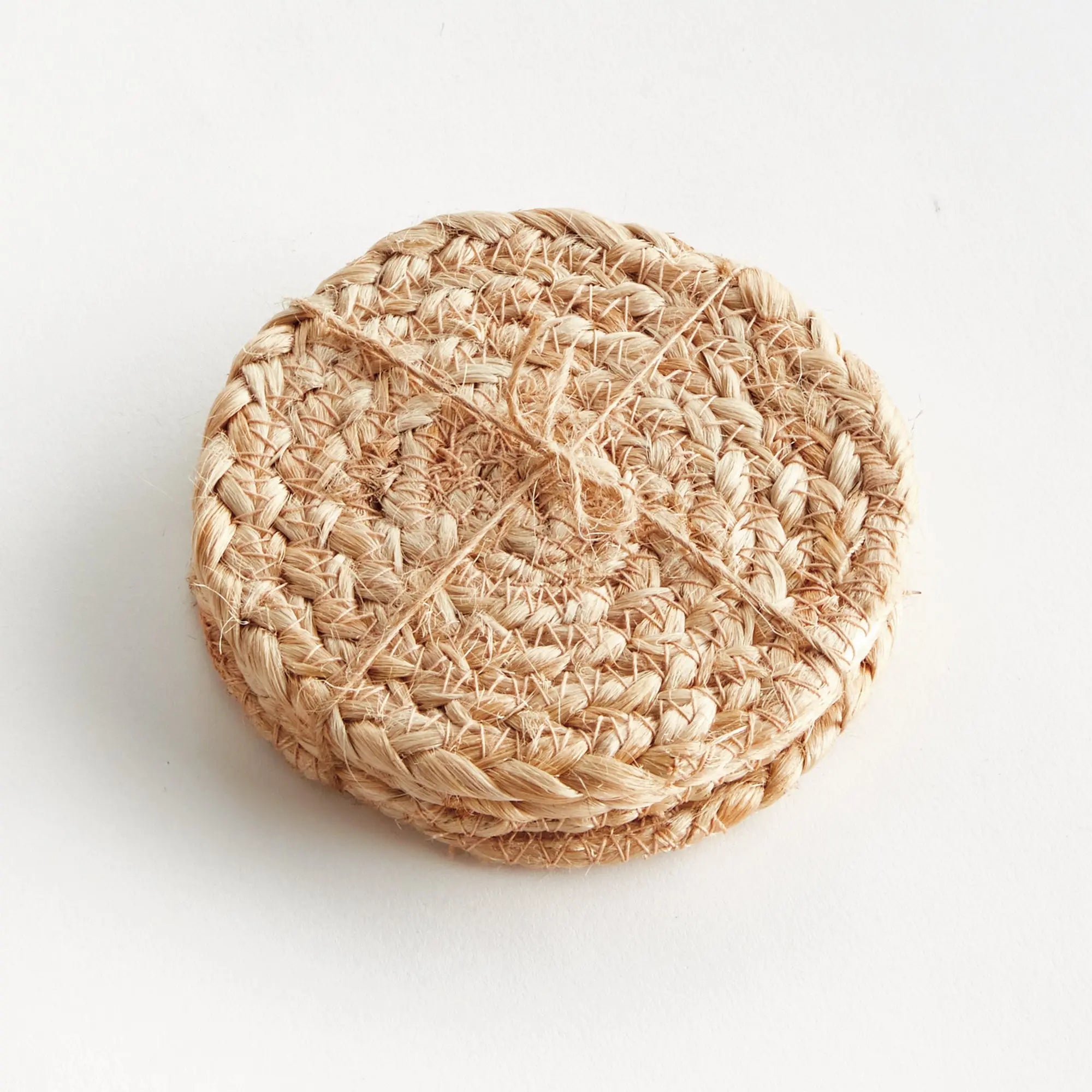 Woven beige coaster on a white background