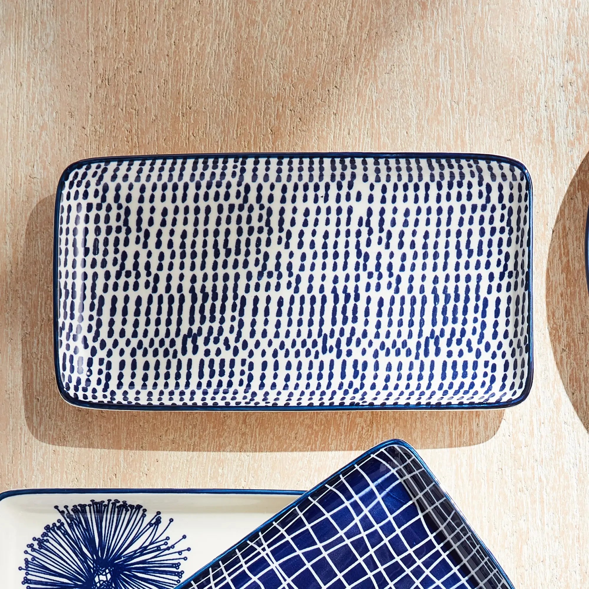 Stria Speckled 8" Trays Set of 4 - dark blue and white ceramic serving trays with speckled pattern for appetizers and entertaining