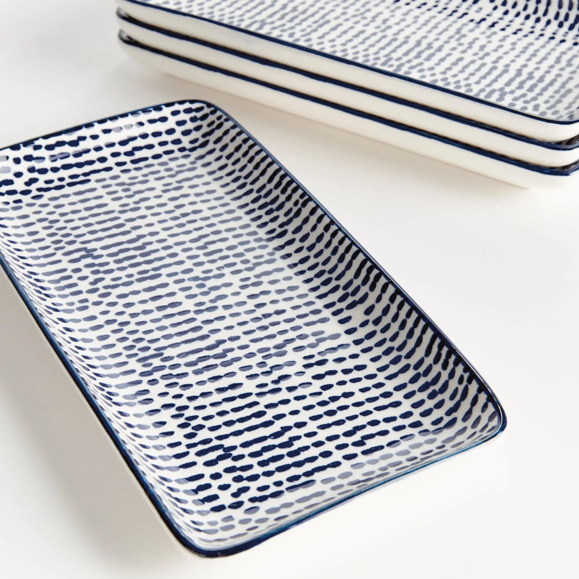 Stria Speckled 8" Trays Set of 4 - dark blue and white ceramic serving trays with speckled pattern for appetizers and entertaining