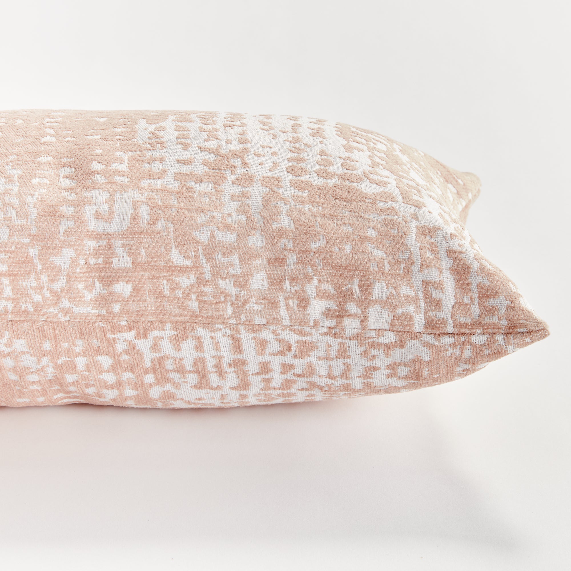 Blush Rectangular pillow with a textured pattern on a white background