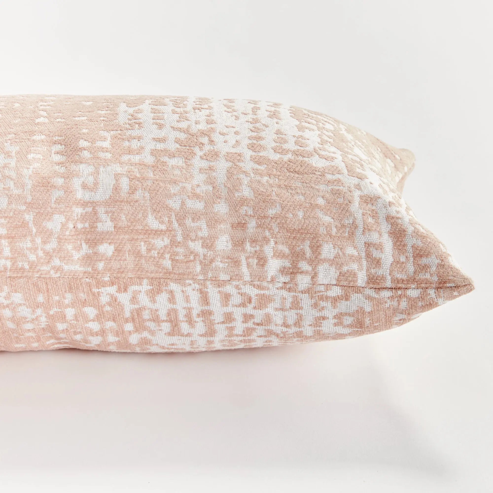 Blush Rectangular pillow with a textured pattern on a white background