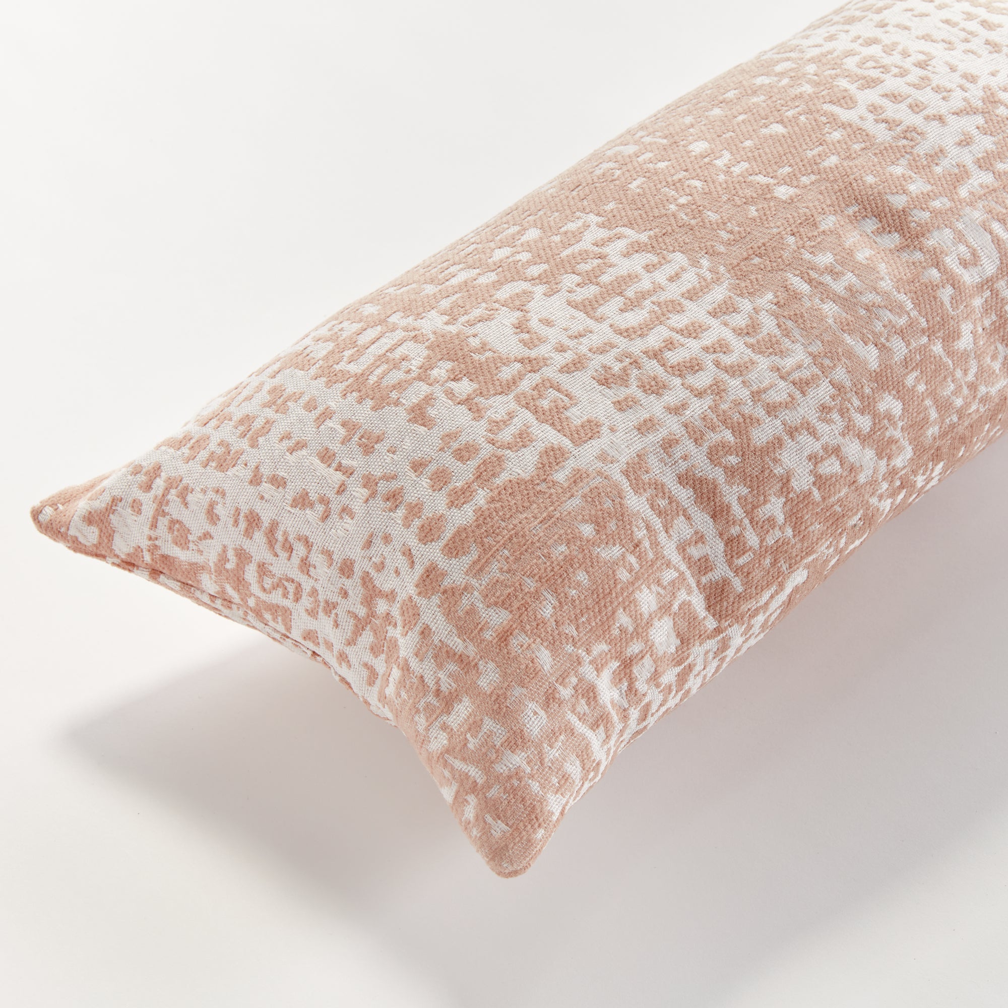Blush Rectangular pillow with a textured pattern on a white background
