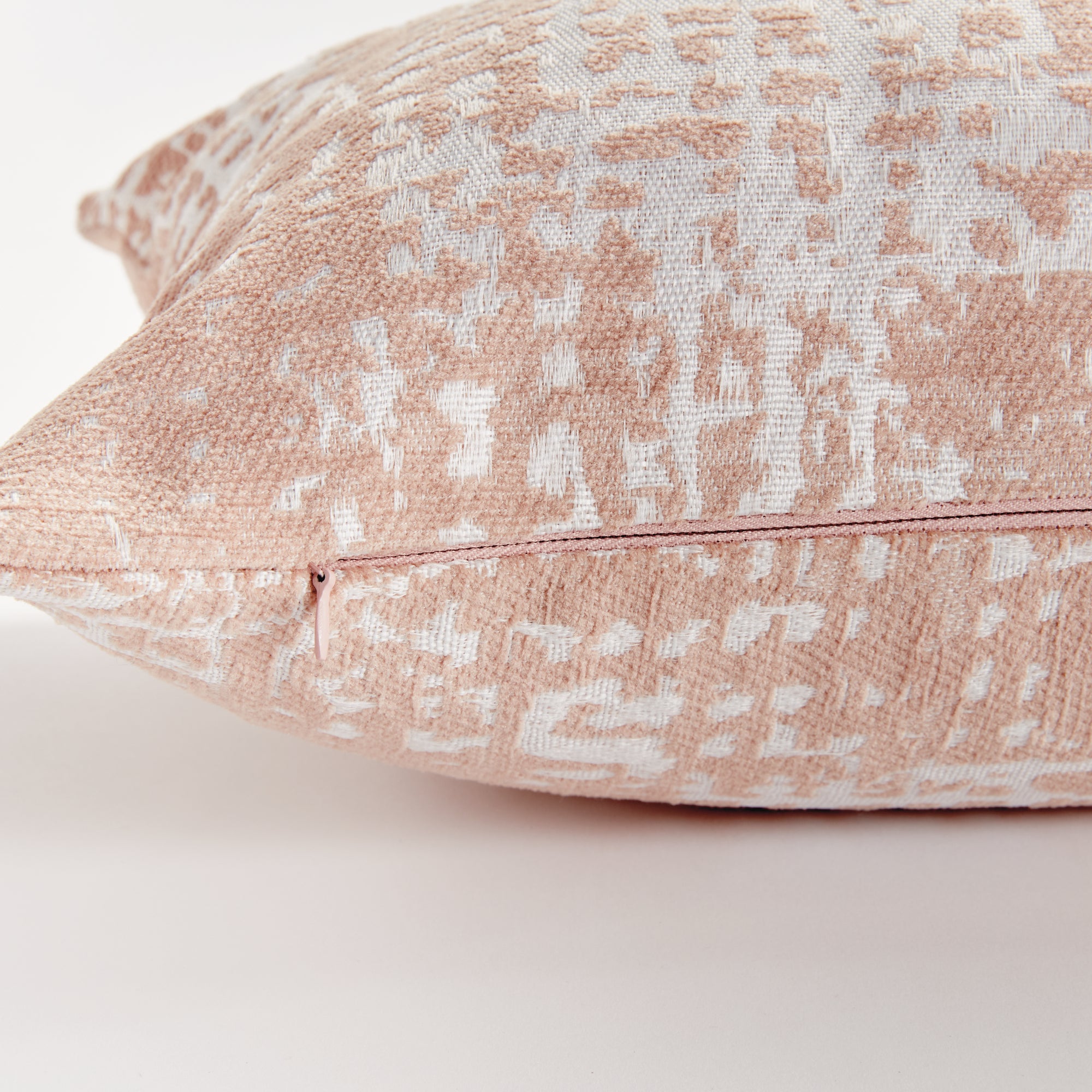 Blush Rectangular pillow with a textured pattern on a white background