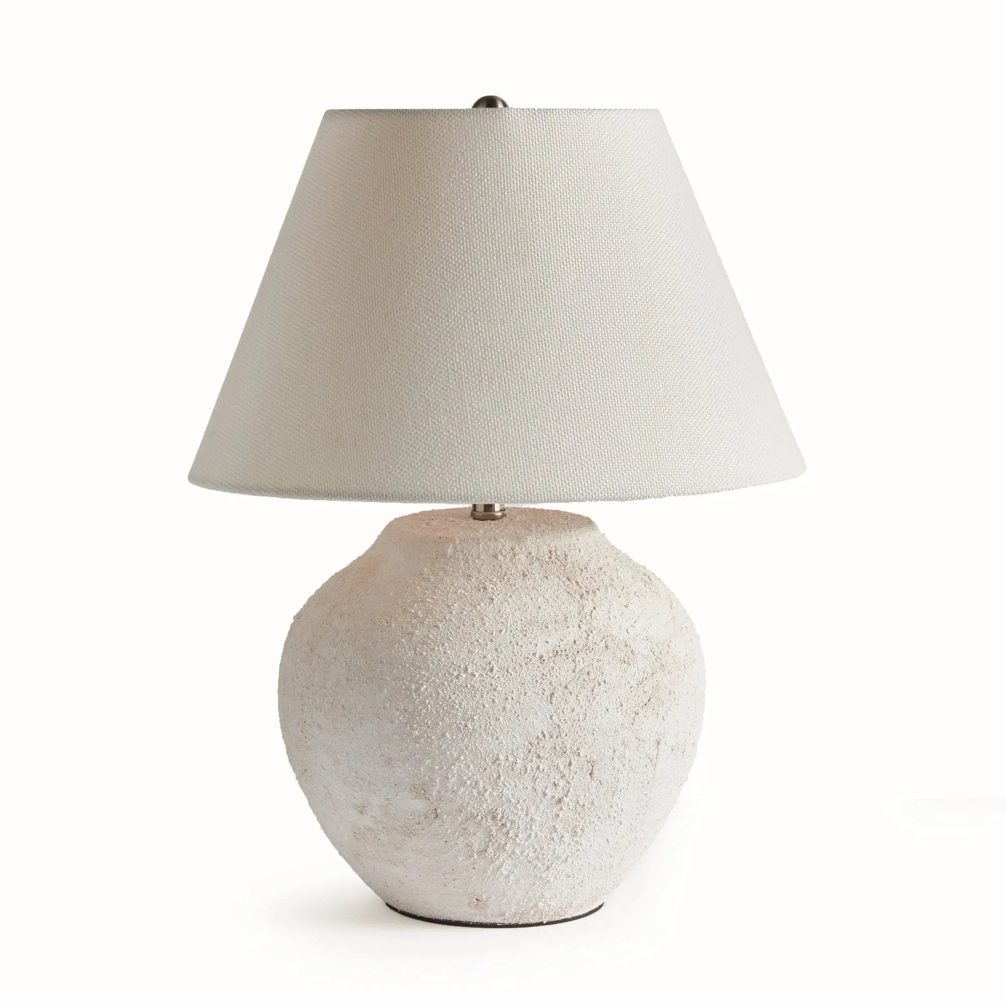 Theo Table lamp with textured white base and beige lampshade on a white background