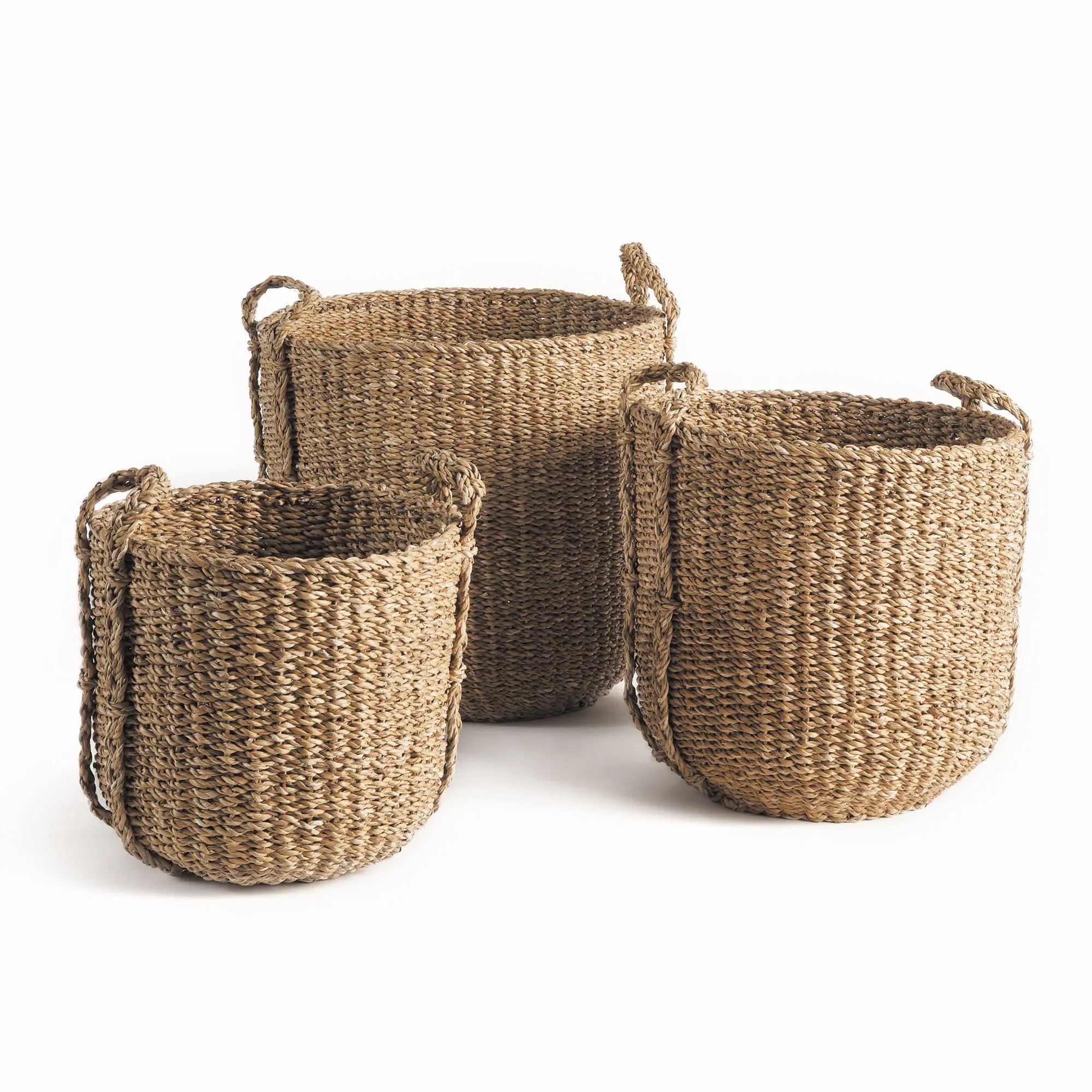 Three woven baskets of different sizes on a white background