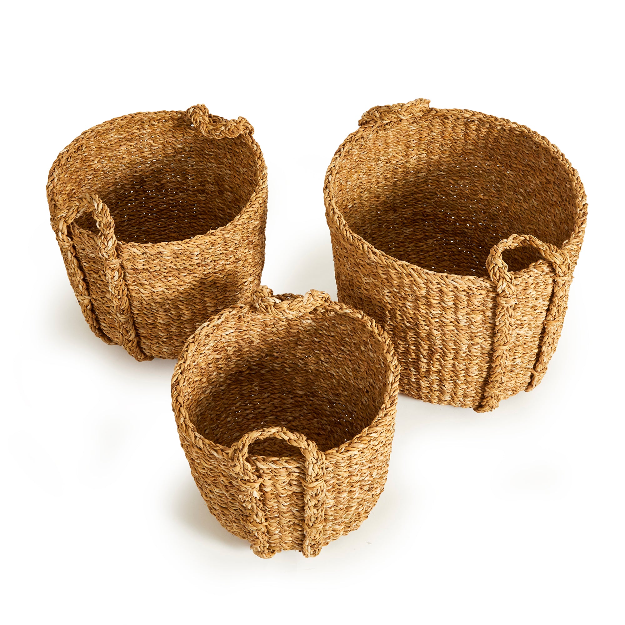 Three woven baskets made of natural material on a white background