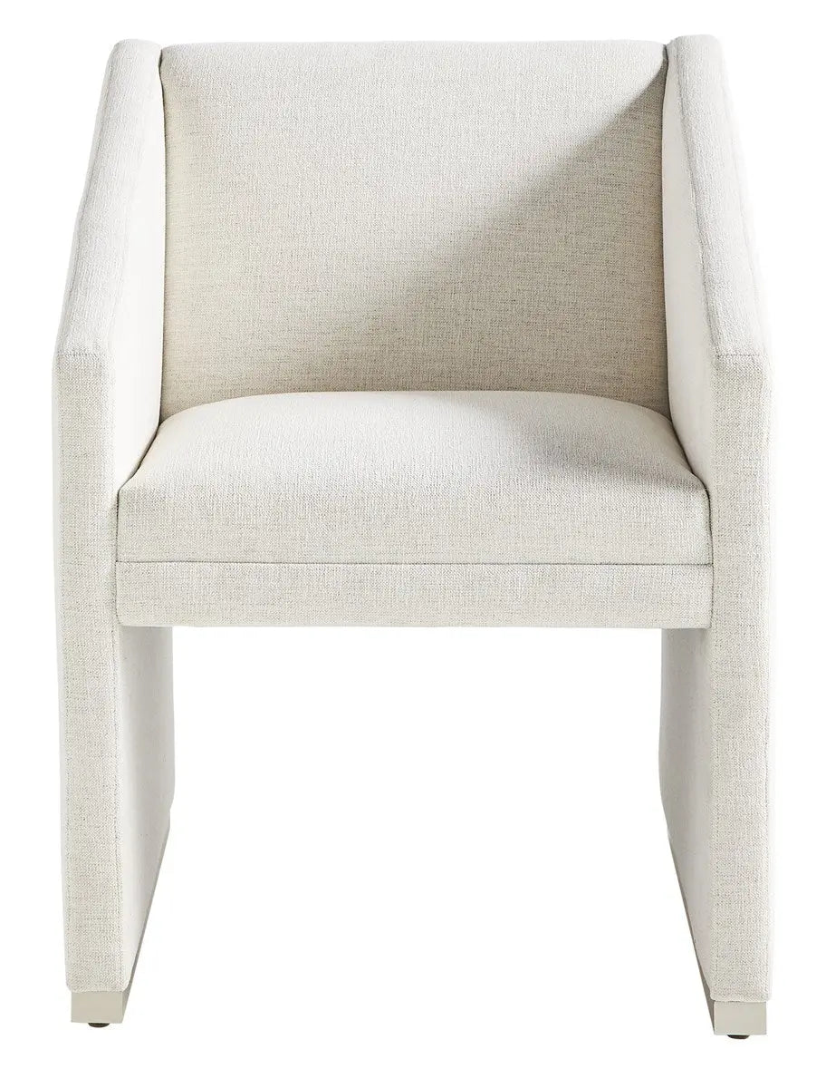 Dunecrest Dining Chair, an upholstered dining chair with arms, covered in light Nomad Snow fabric and featuring a modern Cava wood finish.