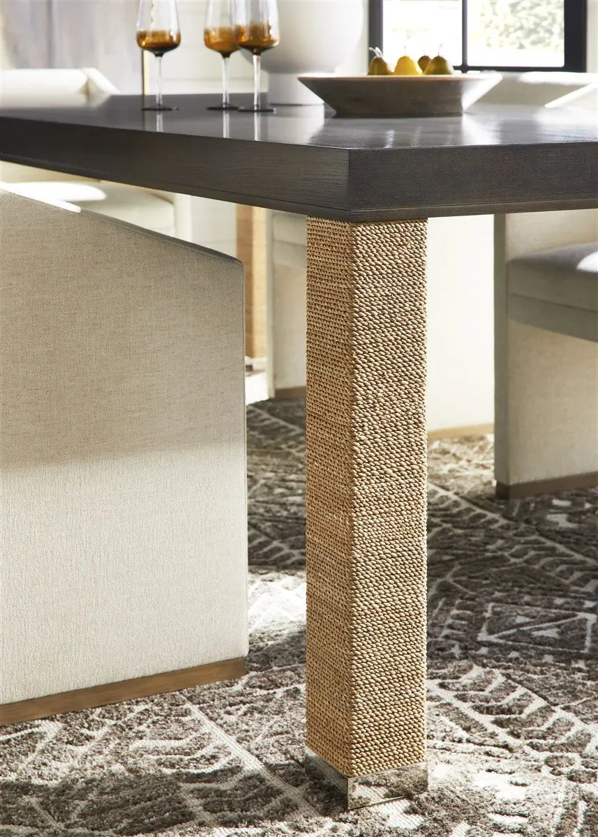 Dunecrest Dining Chair, an upholstered dining chair with arms, covered in light Nomad Snow fabric and featuring a modern Cava wood finish.