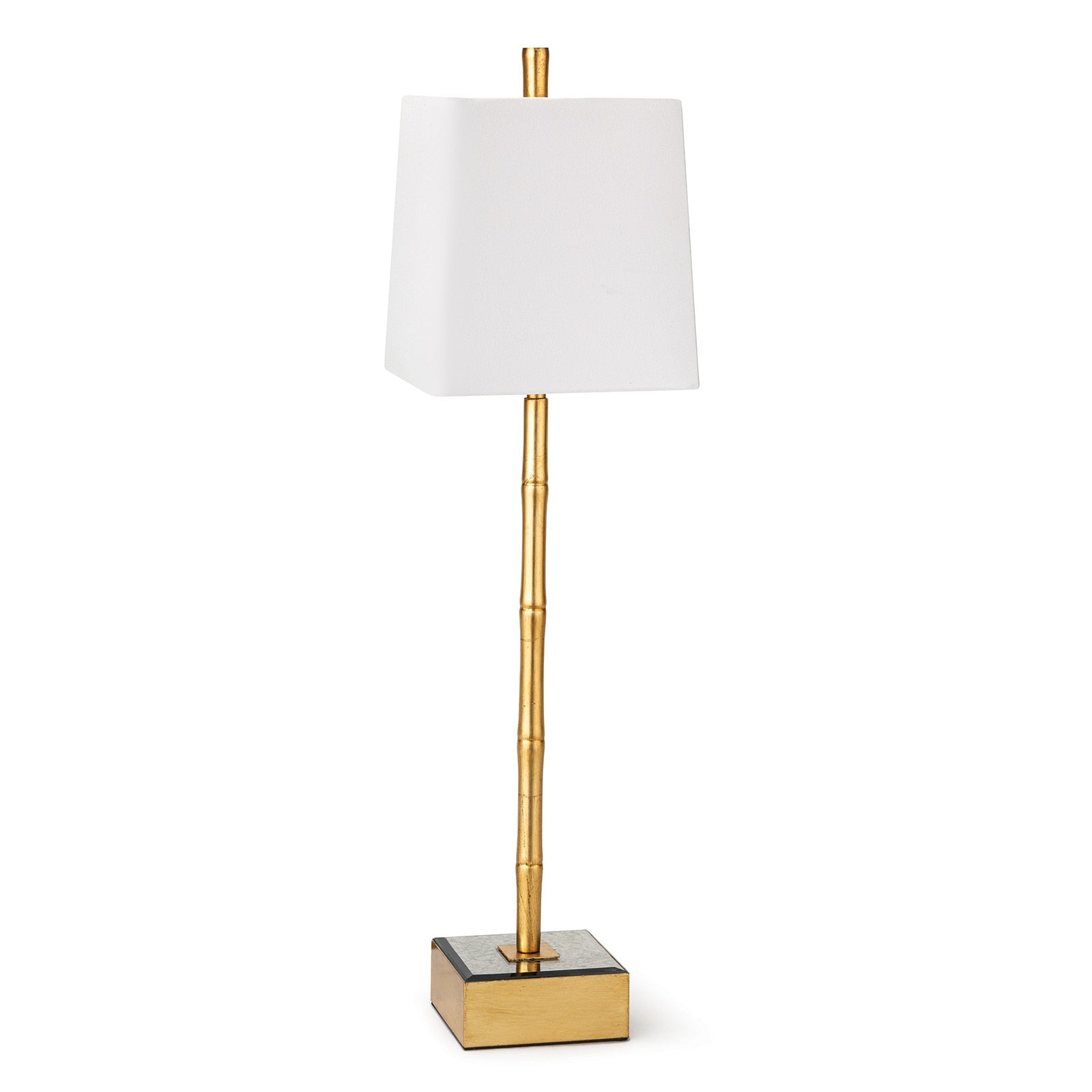 Gold table lamp with a white shade on a white background