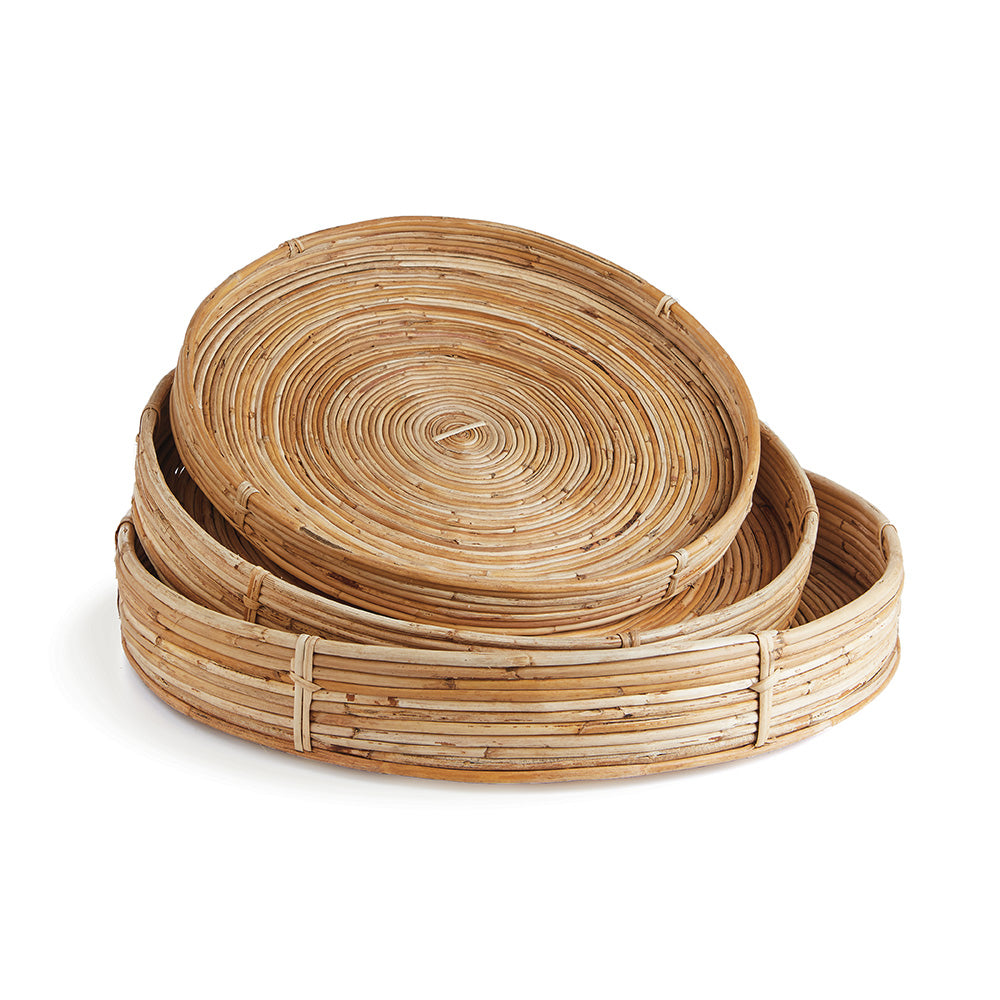 Set of three woven rattan trays on a white background