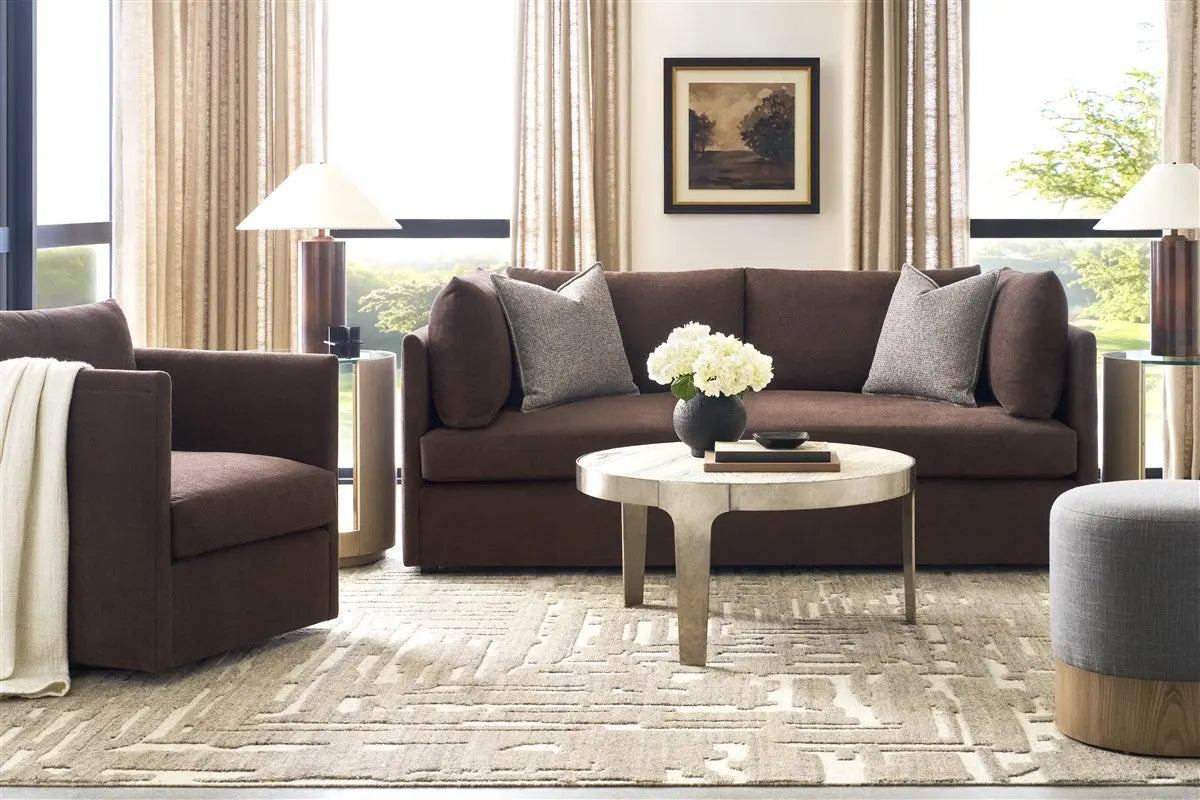 Modern living room with brown sofa, armchair, and coffee table.