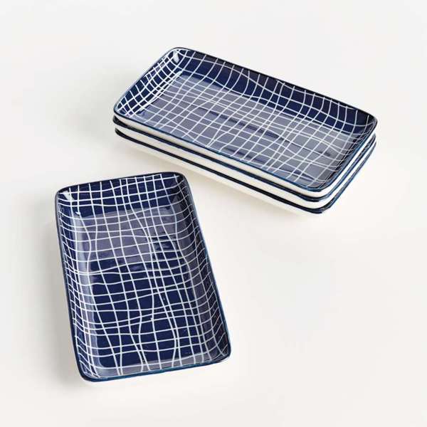 Two rectangular ceramic trays with blue grid patterns on a white background