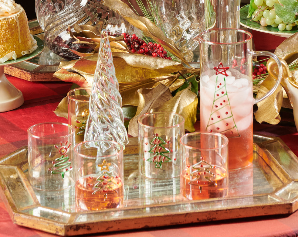 Decorative glassware with Christmas tree designs on a tray