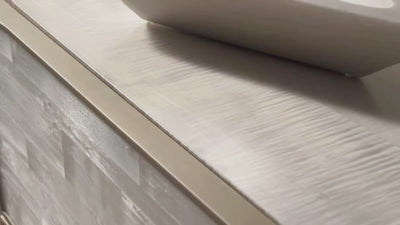 Splendor Selenite Chest, a three-drawer low dresser with drawer fronts faced in natural white selenite, a bleached maple case, and thin soft bronze metal accents.